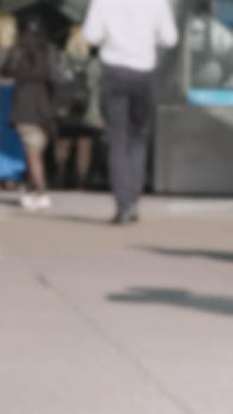 Defocused-Vertical-Video-Close-Up-London-Commuters-Walking-Escalator-Train-Tube-UK